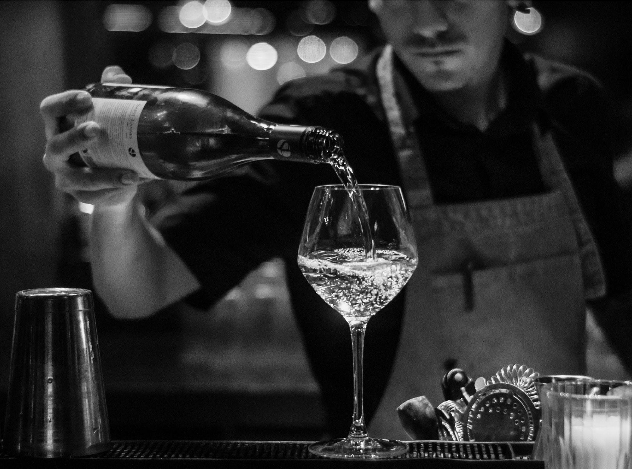 Bartender pouring wine into a glass
